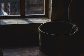 Old wooden dishes by the window 