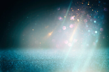 background of abstract glitter lights. gold, blue, silver and black. de focused