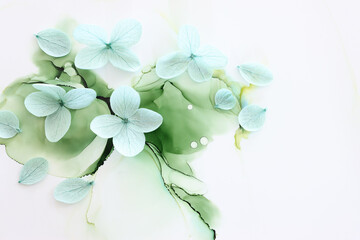 Creative image of pastel mint green Hydrangea flowers on artistic ink background. Top view with copy space