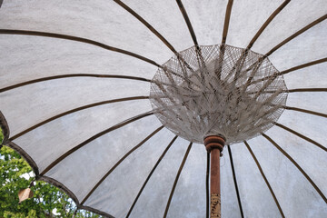 Vintage bamboo umbrella. Inside of umbrella with wooden frame and thread pattern.