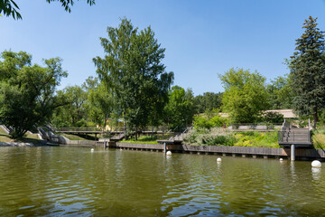 Fototapeta na wymiar Pond in sunny weather in the city park.