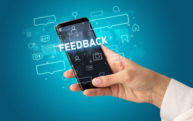 Hand using smartphone with social media concept