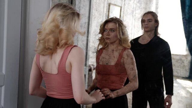 two young dancers are dancing in front of old dirty mirror, dramatic dance performance