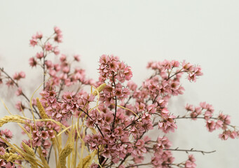 pink artificial flowers, a bouquet of silk flowers on a table on a white background