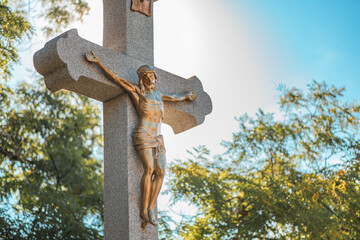 Crucifixion, statue of Jesus Christ on concrete cross on cemetery