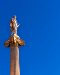 Fototapeta premium Apollo the ancient Greek god of poetry and music under blue sky with space for your text, Athens Greece
