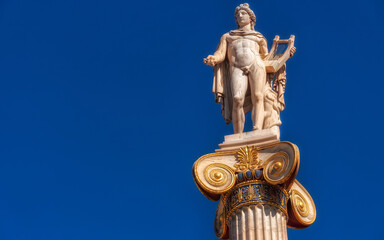Apollo the ancient Greek god of poetry and music under blue sky with space for your text, Athens...