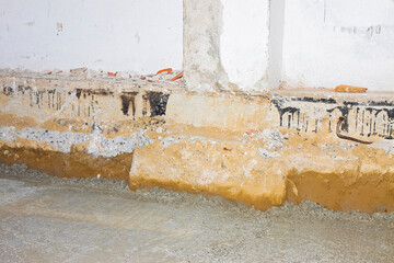 Preparatory stage for the construction of a ventilated crawl space in an old brick building against...