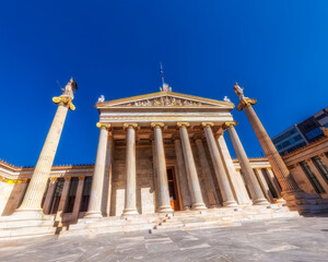 Fototapeta na wymiar the national Greek academy of Athens impressive neoclassical building front facade with space for your text on the blue sky