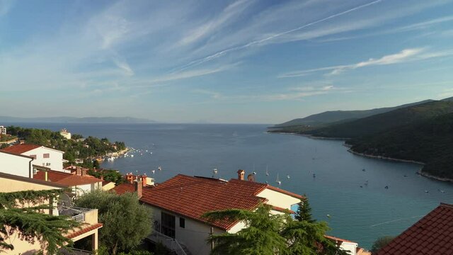 Arial view of the sea bay, on a summer sunny day, the movement of boats, Rabac, Istra, Croatia.