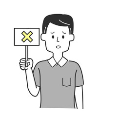 バツが書かれた札を持っている男性