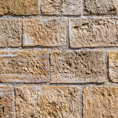 brown limestone wall closeup, seamless natural background