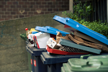 Trash bin overflowed with carton