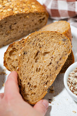 fresh bread with oatmeal and seeds, closeup vertical