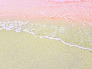 Pink beach and bright sea waves