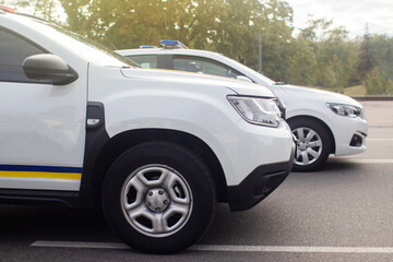 Close-up of police cars without labels or markings. A parade of cars of the defenders of order and tranquility. The work of the special services. Place for text