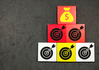 Colored cube with target and money icons on top.Business concept.
