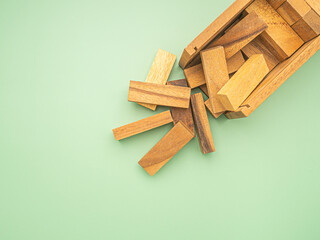 Table game made of wooden blocks isolated on a green background. Space for text