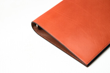 A personal organizer made of leather.