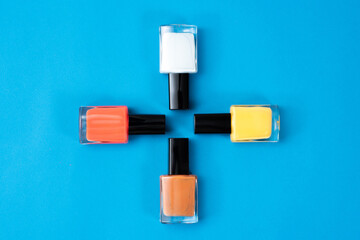 Bright nail polish on a blue background. Close-up