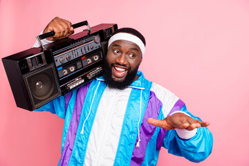 Photo of young black man happy positive smile dj hipster music lover rhythm isolated over pink...