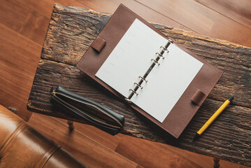 A personal organizer made of leather.