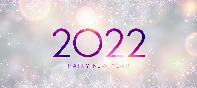 Fogged glass 2022 sign on bokeh snowflakes background..