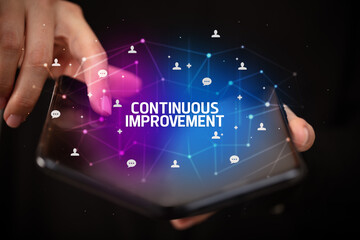 Businessman holding a foldable smartphone, new technology concept