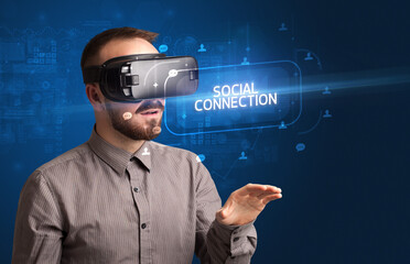 Businessman looking through Virtual Reality glasses, social media concept