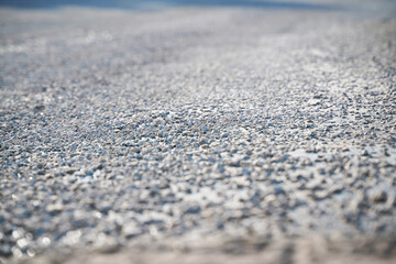 Fototapeta na wymiar white and gray pebbles on a flat surface with blue shades, blur all around