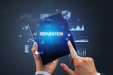 Businessman holding a foldable smartphone, business concept