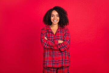Photo of confident young afro american woman hold hands crossed smile pajama party isolated on red...