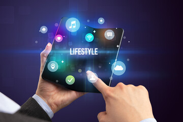 Businessman holding a foldable smartphone