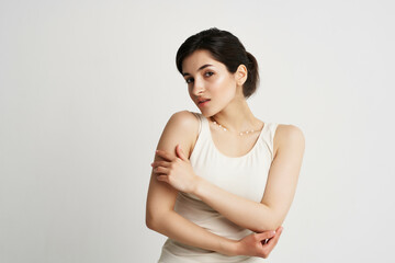 Obraz premium pretty brunette in white tank top clean skin cosmetics moisturizing hygiene