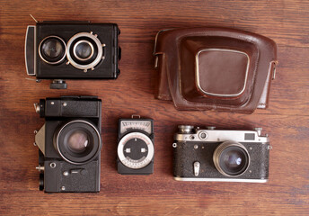 Retro style photo cameras collection on old wooden table