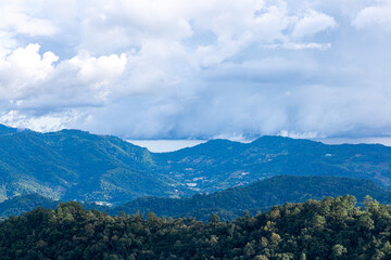 View of high hills and big clouds in the blue sky on Doi Mon Chaem, Chiang Mai, Thailand.