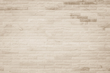 Empty background of wide cream brick wall texture. Beige old brown brick wall concrete or stone textured