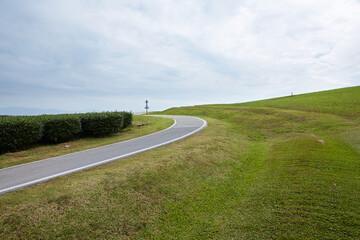 Closeup of road in sunny meadow environment outdoors