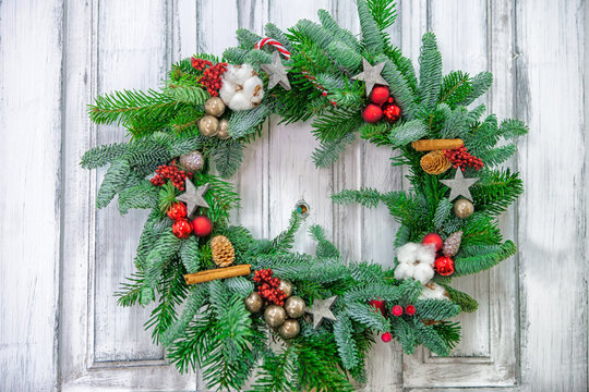 wooden door with a christmas wreth. White door with wood texture