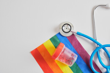 hearts in a test jar, stethoscope and lgbtq flag, sperm and egg donation for gay couples