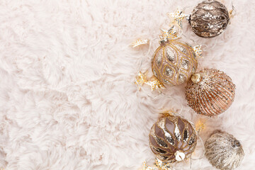 Golden christmas balls with wool background.