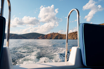 Fototapeta premium Motor yacht cruising in the sea, view from the stern