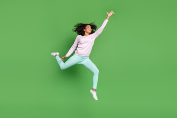 Full length profile photo of impressed young brunette lady jump wear pullover pants shoes isolated on blue background