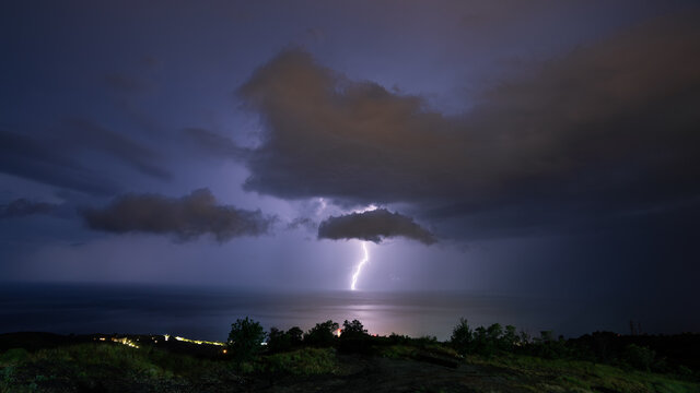 Lightning during a night thunderstorm over the Black Sea, horizontal, panoramic.