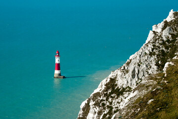 This is a scenic view by day on the blue sea and Beachy head lighthouse, white cliffs of the Seven...