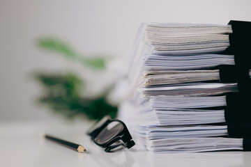 Close-up stacking of office working document with paper clip folder on white table