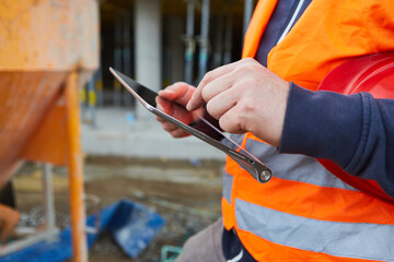 Worker with tablet computer during construction planning
