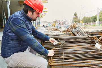 Foreman checks the quality of the reinforcement bars