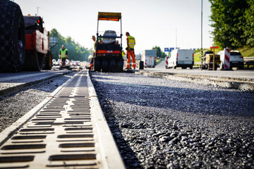 Sewer grate constructing drain and asphalt road in the middle of highway
