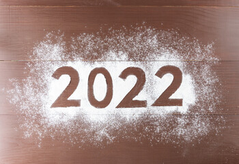 Numeral 2022 on brown wooden background. Christmas and New Year concept. Horizontal orientation,...